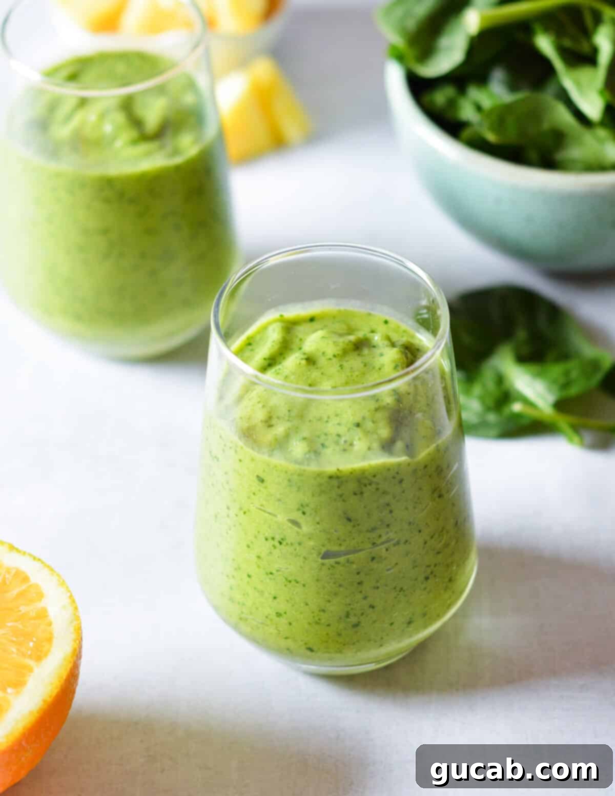 Sun-Kissed Mango Creations 20 Two vibrant tropical green smoothies with mango, spinach, and avocado.