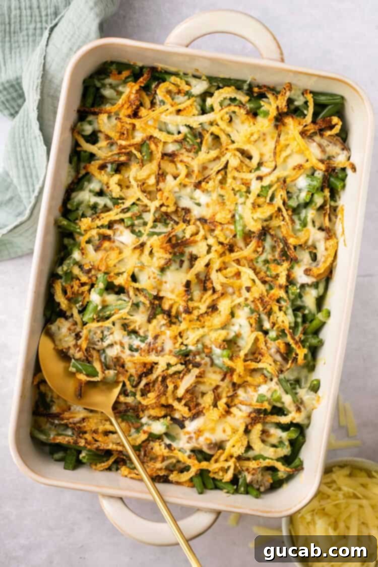 A wholesome green bean casserole, generously topped with crispy fried onions, showcasing a healthier yet equally delicious version of the holiday classic.