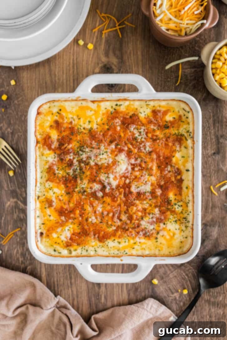 A creamy and cheesy corn casserole, baked to golden perfection, with visible corn kernels and a hint of seasoning, ready to be enjoyed.
