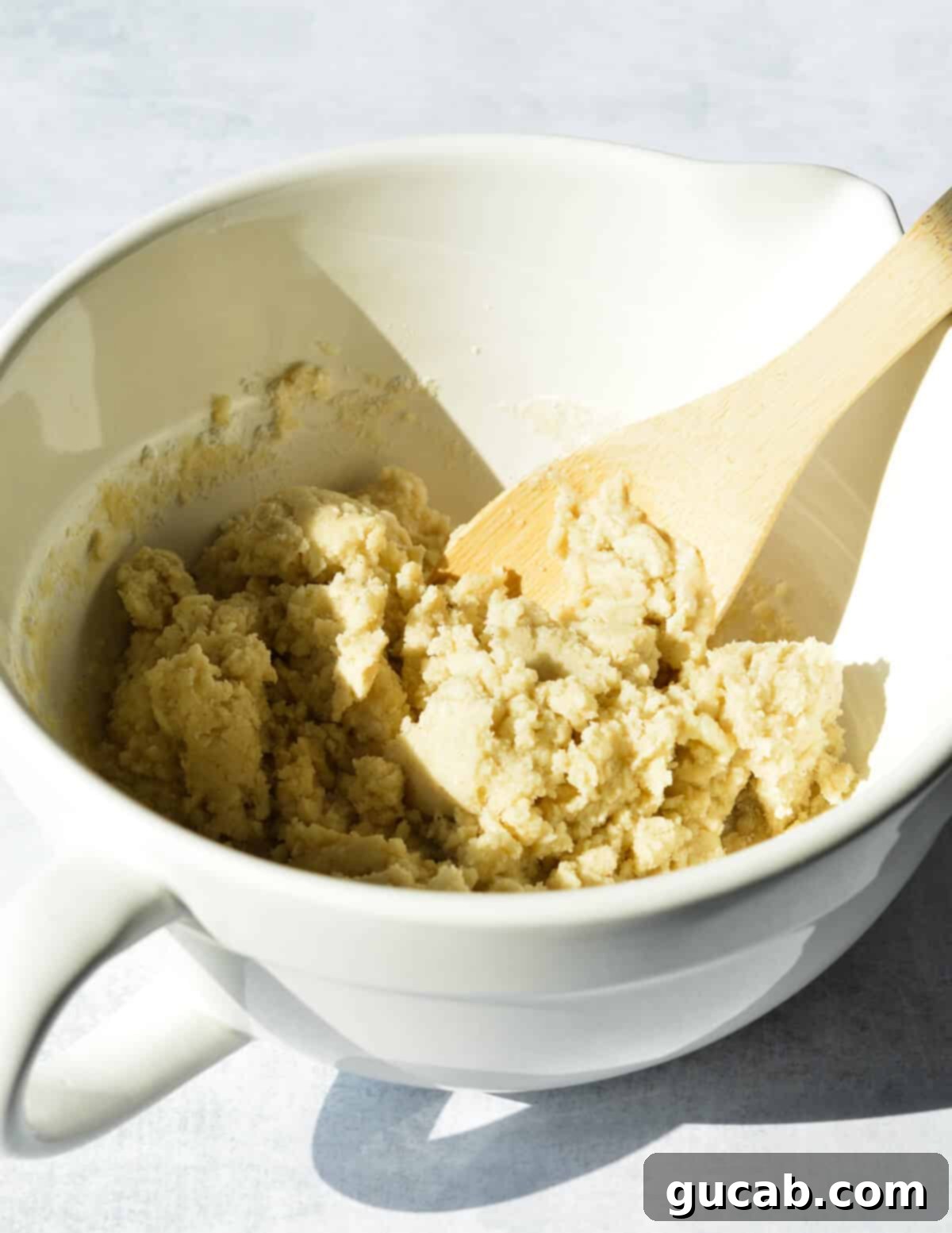 A bowl containing prepared gluten-free shortbread dough, ready for baking.