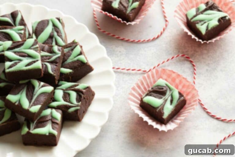 19 Peppermint Desserts to Sweeten Your Holidays 12 chocolate mint fudge squares on a plate.