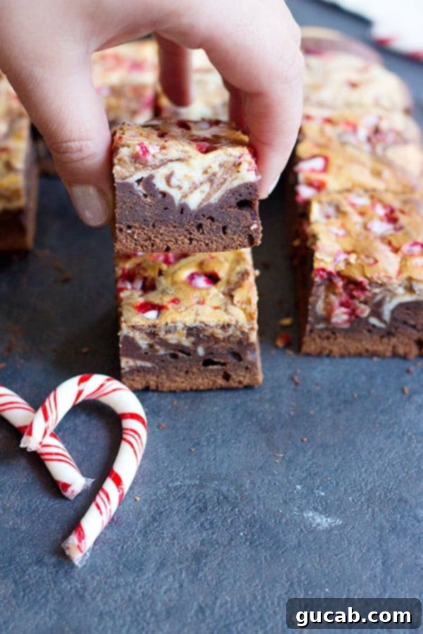 19 Peppermint Desserts to Sweeten Your Holidays 10 hand holding a fudgy peppermint brownie.