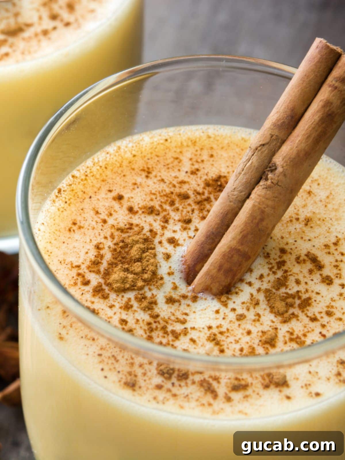 A festive holiday spread featuring various eggnog desserts, including cake, cookies, and a drink, set against a cozy backdrop.