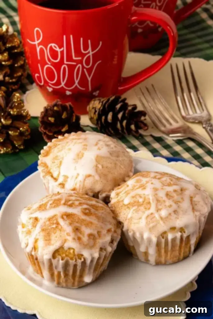 A plate of golden-brown eggnog muffins, lightly dusted with powdered sugar, ready for breakfast or dessert.