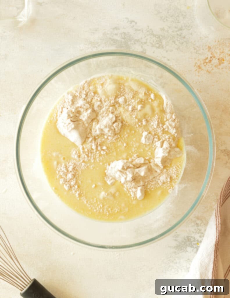 Cassava flour and almond milk being mixed in a bowl to form pancake batter.