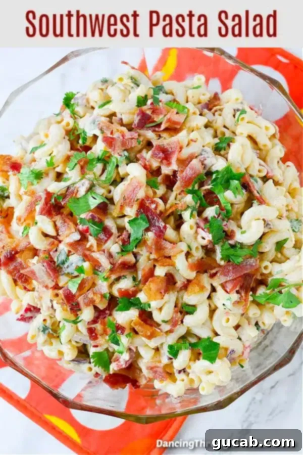 A tantalizing bowl of Southwest pasta salad, loaded with bacon, cheese, pasta, and a zesty chipotle dressing.