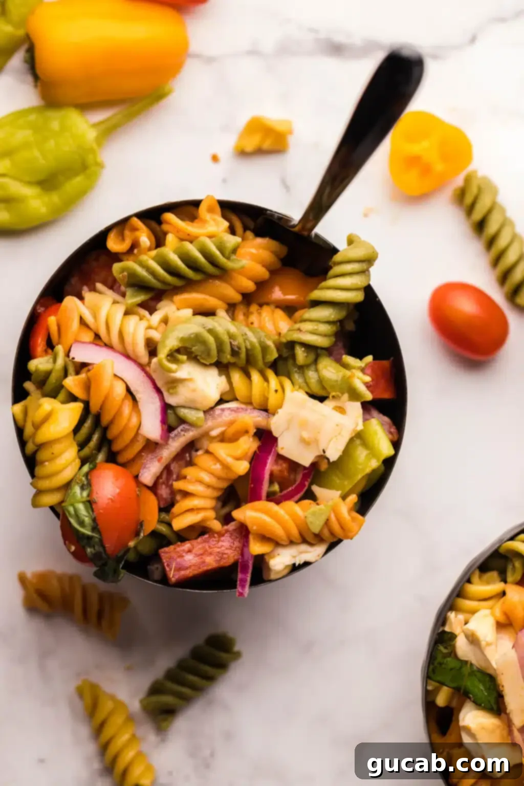 The Ultimate Collection of Irresistible Pasta Salads 5 A hearty bowl of smoked Italian pasta salad, featuring tri-color pasta, grape tomatoes, red onions, and savory pepperoni.