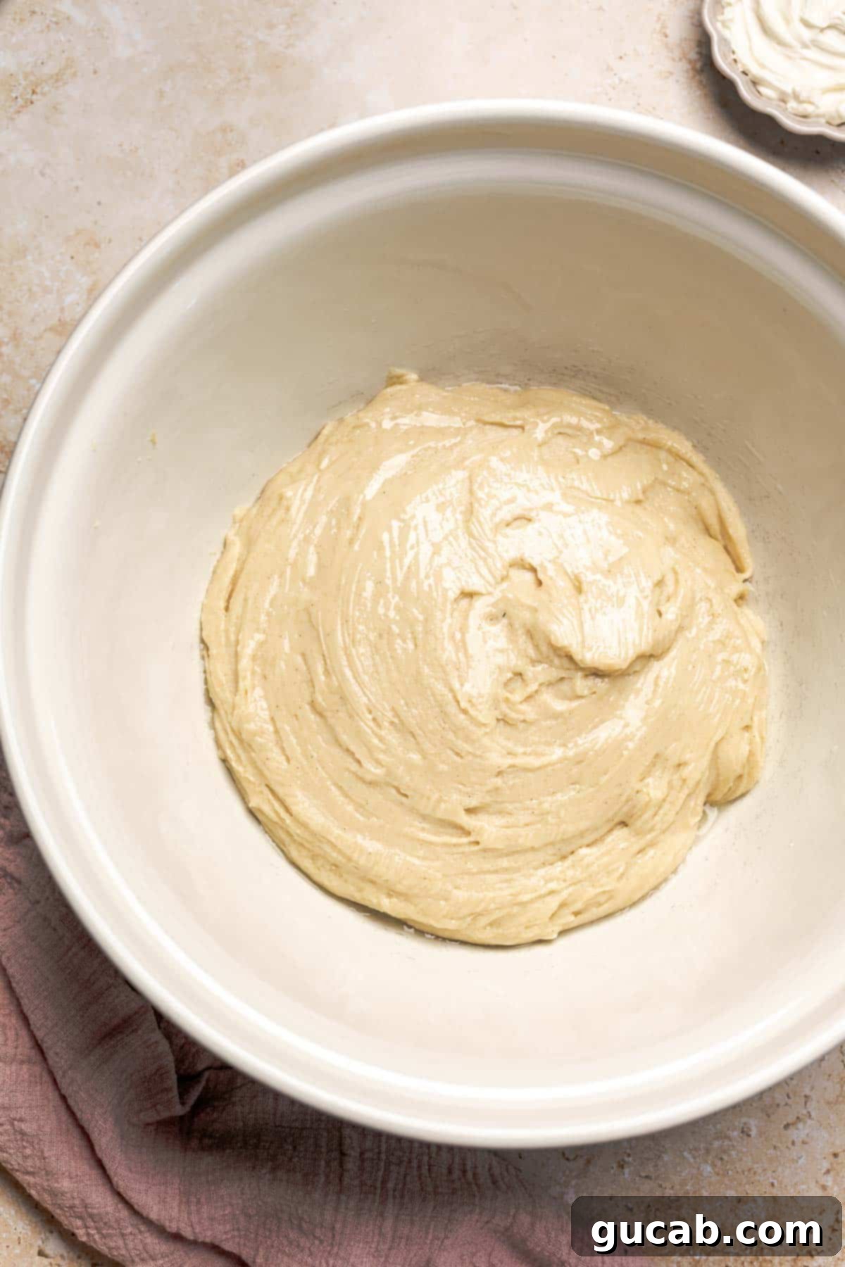 Irresistible Gluten-Free Cinnamon Rolls 10 Smooth and sticky gluten-free dough in a large mixing bowl, thoroughly combined and ready for its first rise.