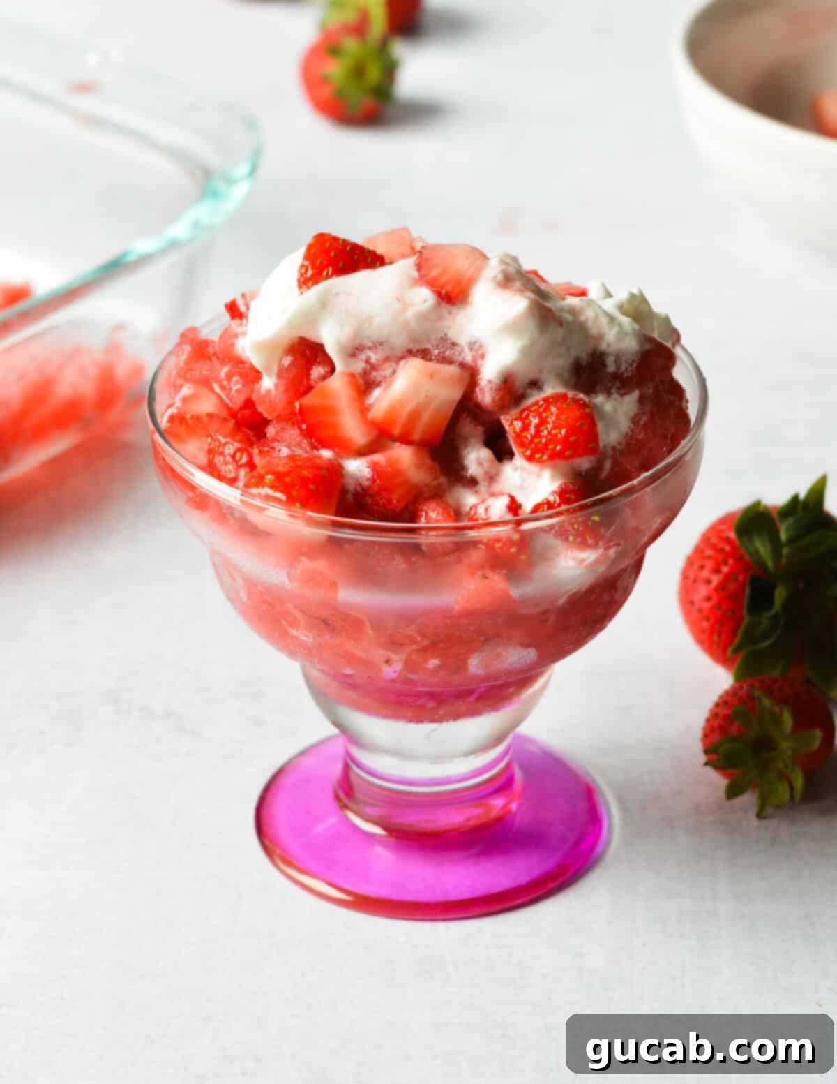 strawberry granita with whipped cream and strawberries on top. 