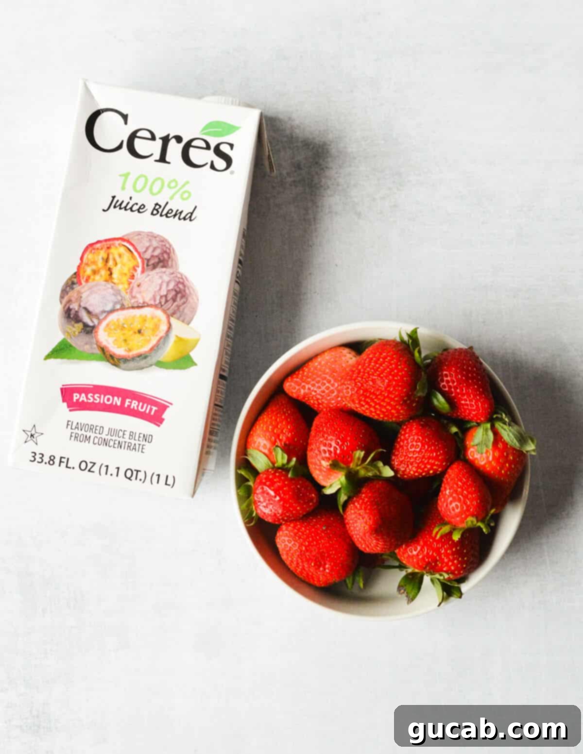 Cere's passion fruit juice and a bowl of fresh strawberries.