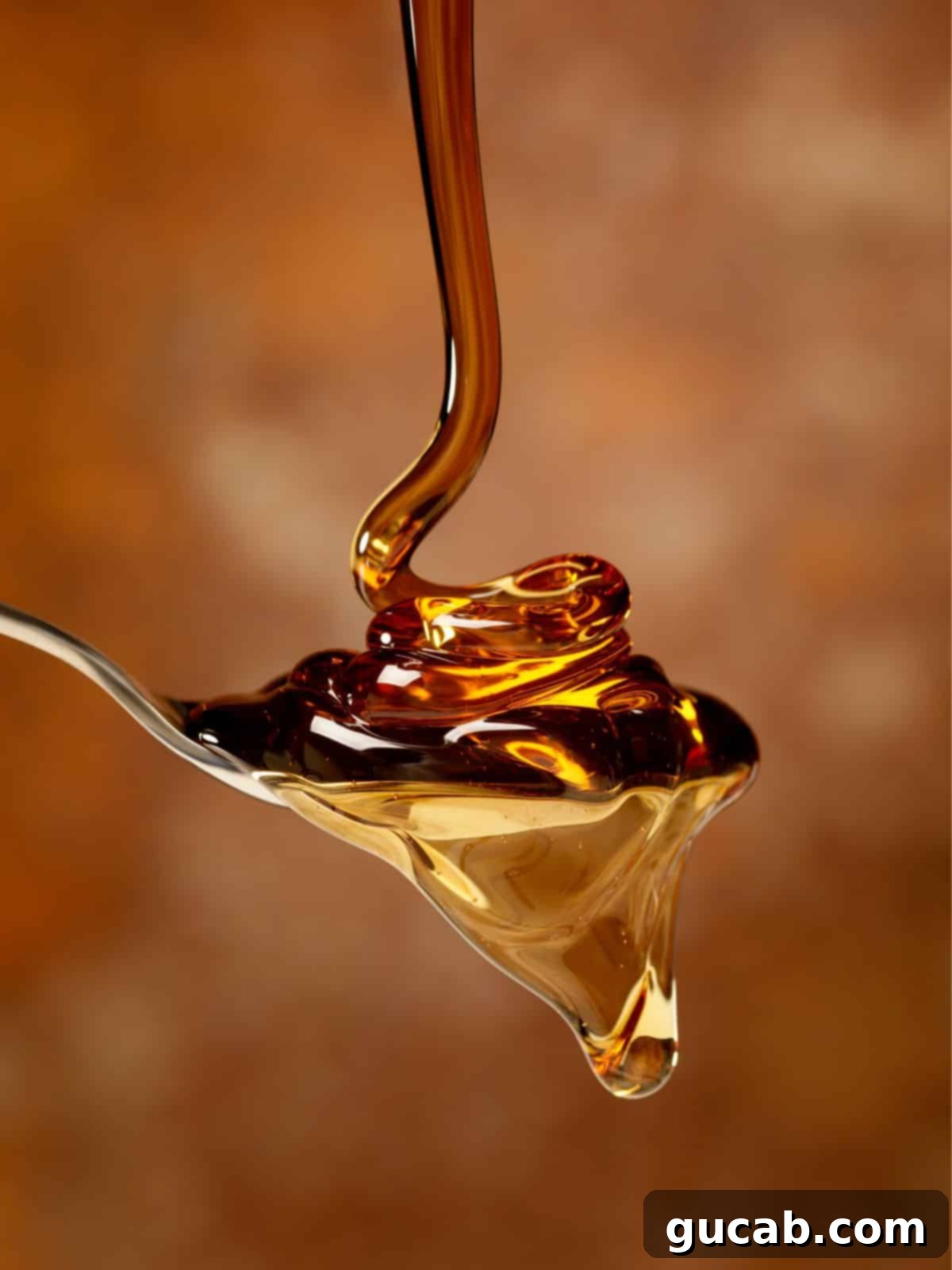 maple syrup drizzling onto a spoon. 