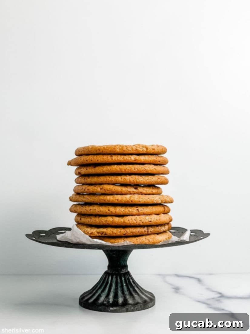 a stack of tahini maple cookies on a cake plate. 
