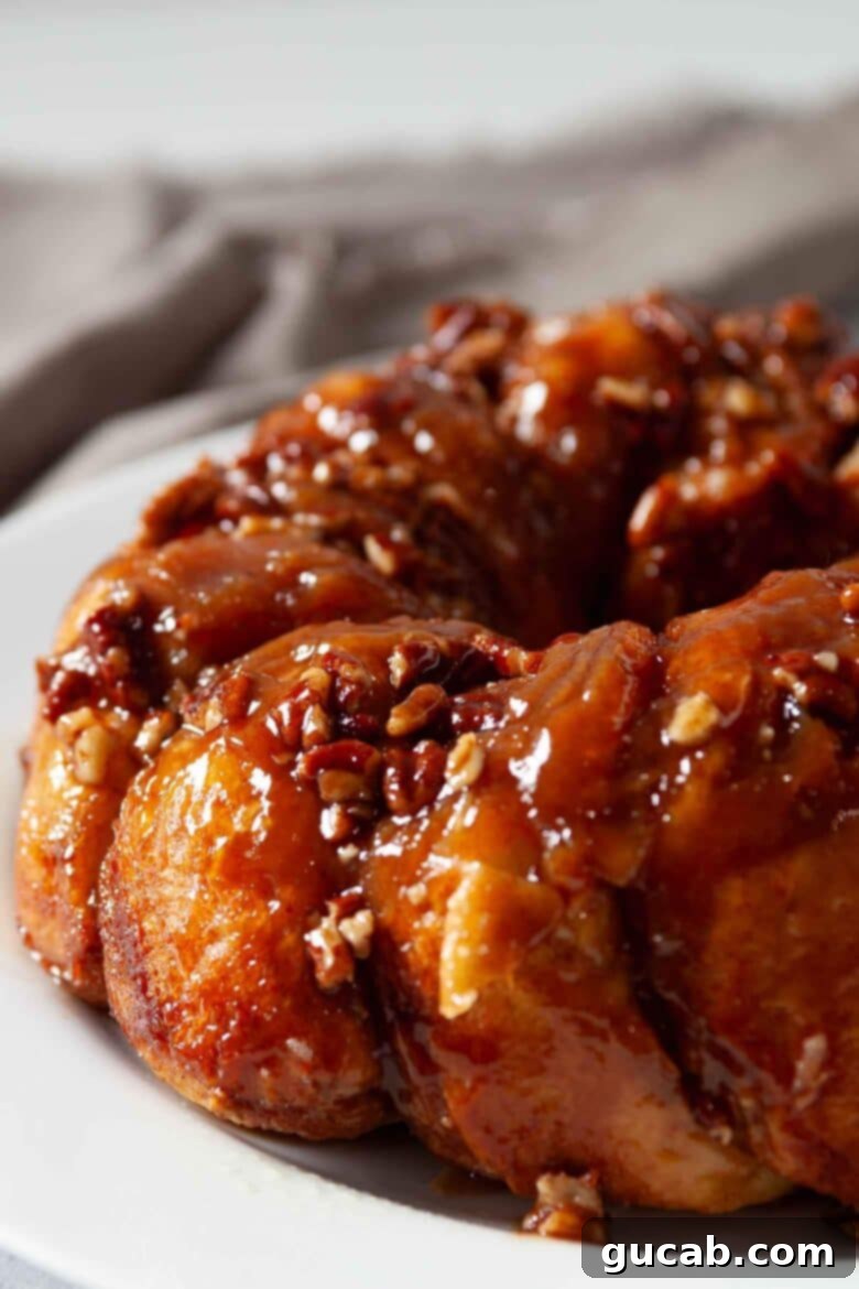 close up of sticky buns with pecans on top. 