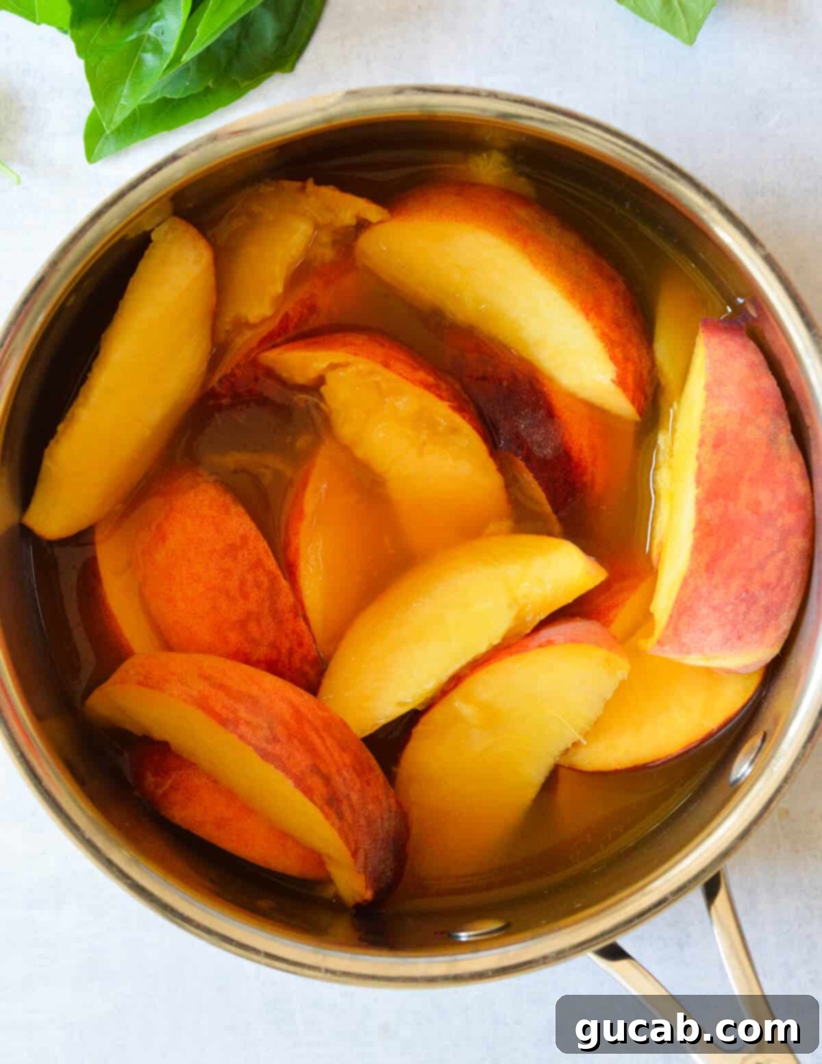 a pot with peaches and basil in it.