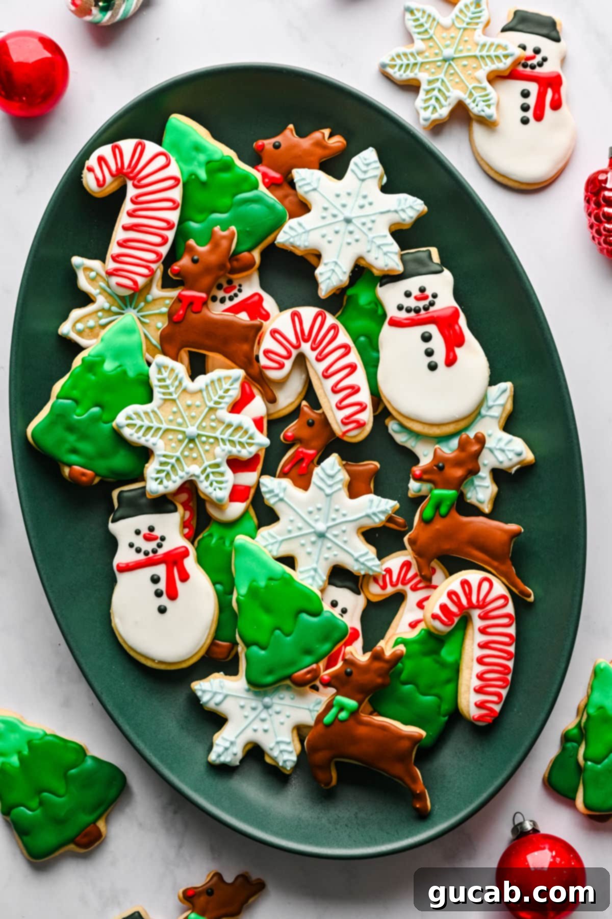 a platter with Christmas themed sugar cookies on it. 