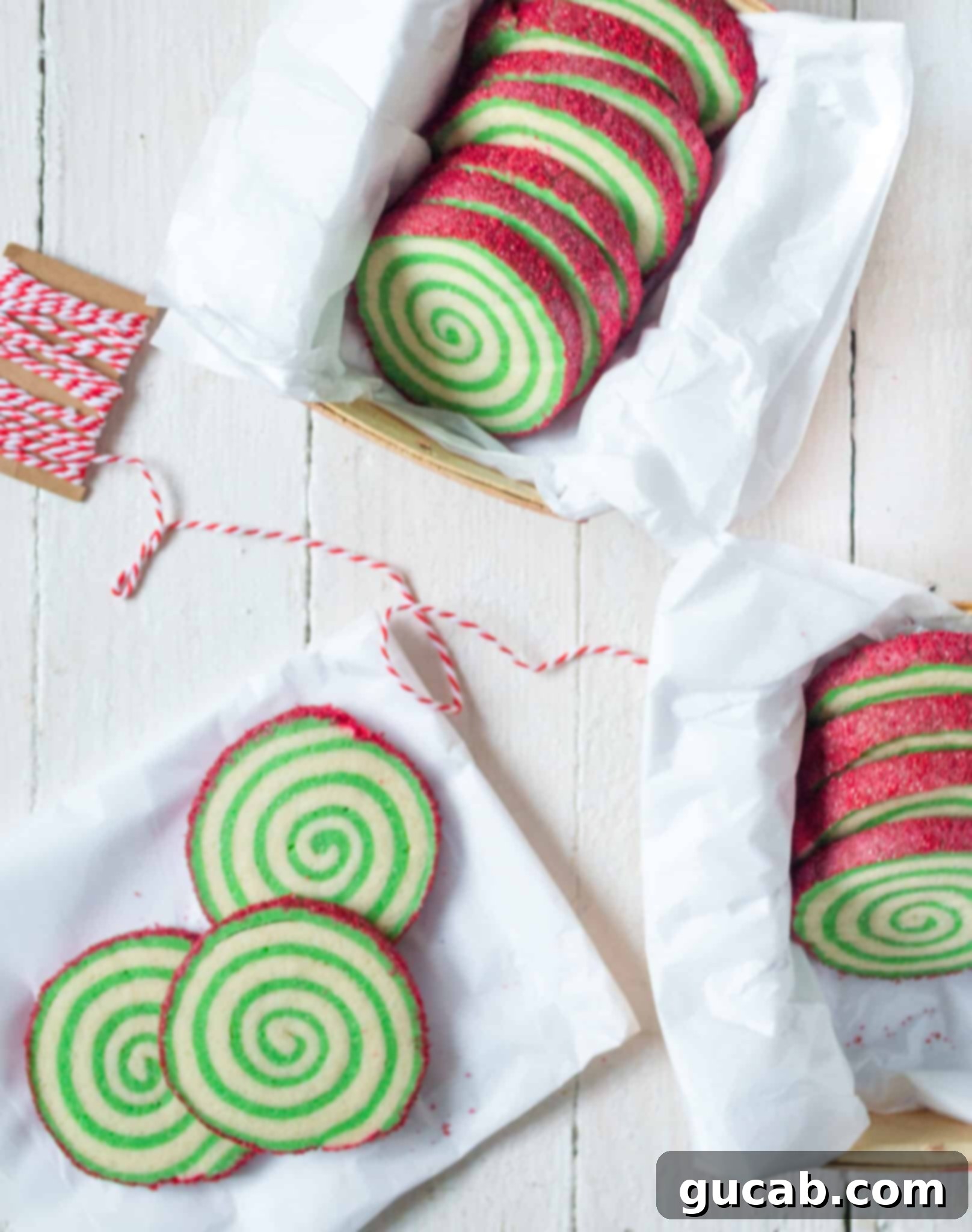 green swirled pinwheel cookies with red sprinkles on the edges. 
