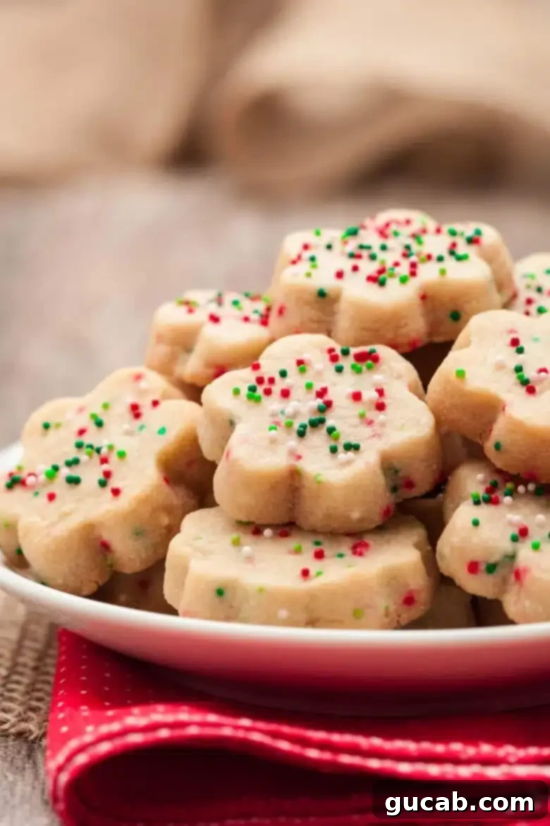 a plate of shortbread cookies with christmas sprinkles on top. 