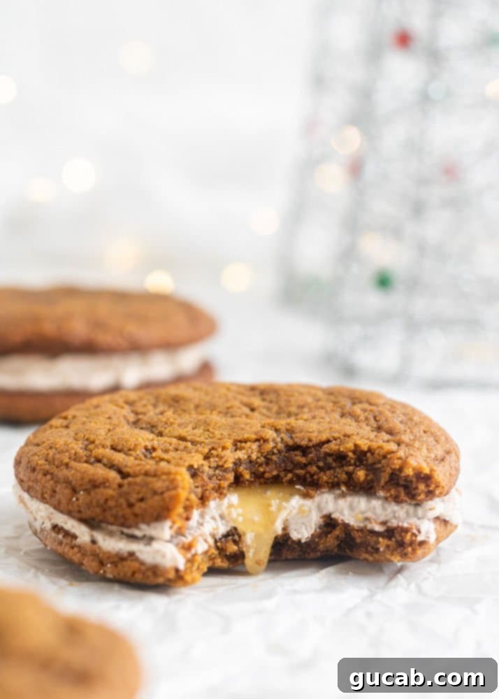 a bite out of a ginger sandwich cookie filled with caramel and buttercream. 