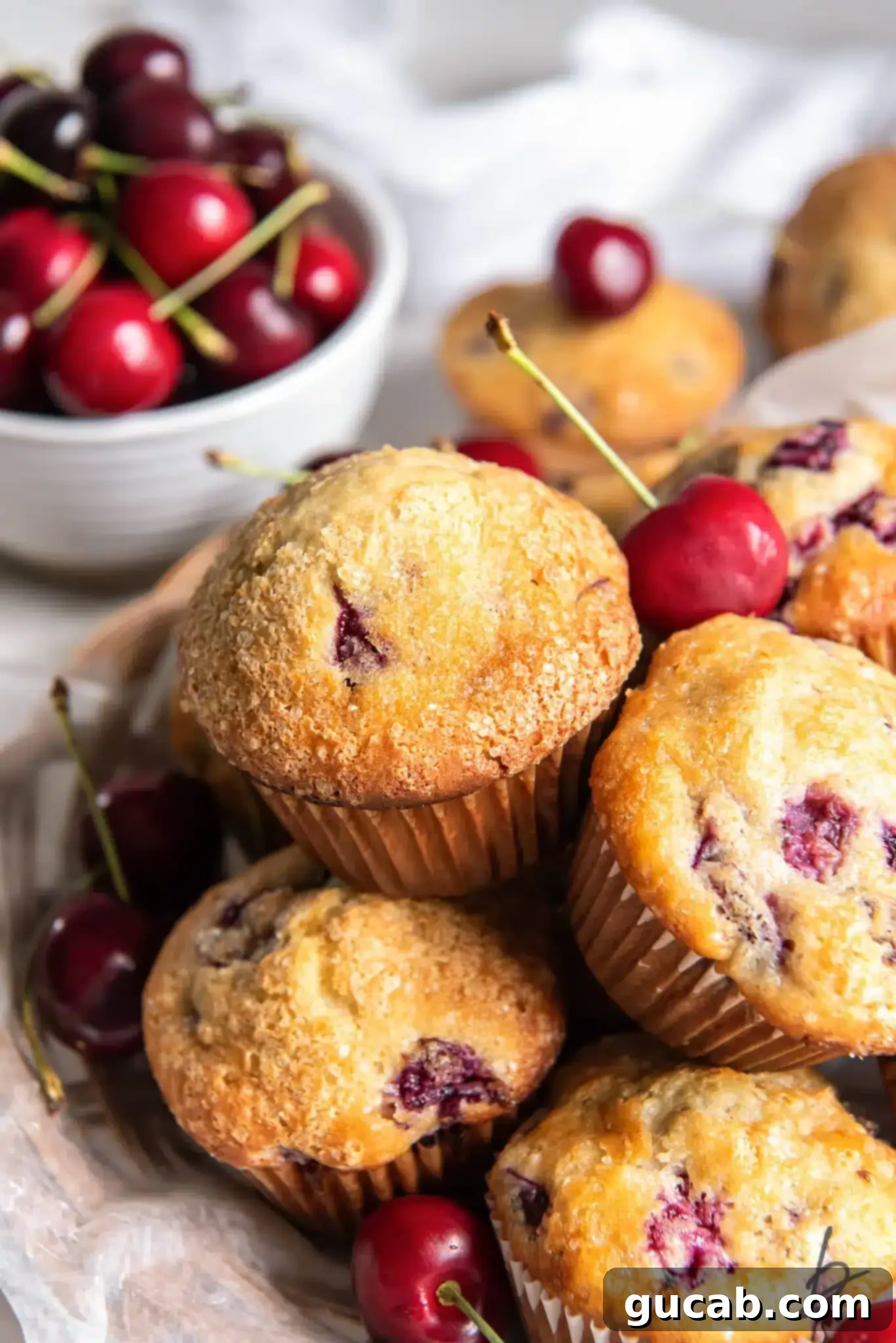 a basket of cherry almond muffins.