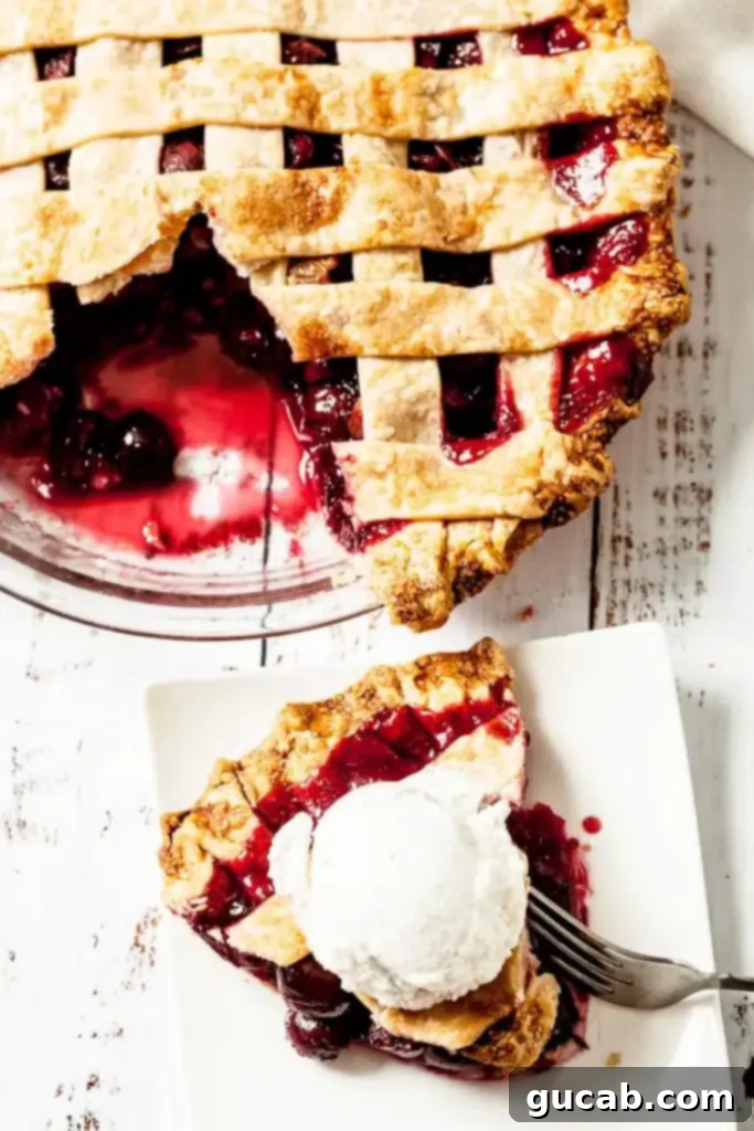 cherry pie with a slice out of it and a slice of pie with ice cream on top.