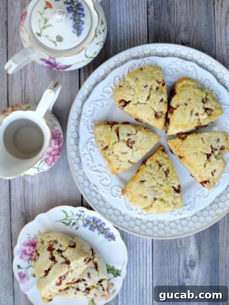 A plate showcasing five freshly baked gluten-free scones, each with a golden-brown hue and rustic charm.