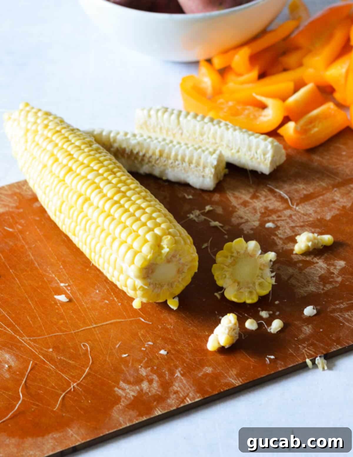 The end of a corn cob precisely cut off, preparing it for the next step in making corn ribs.