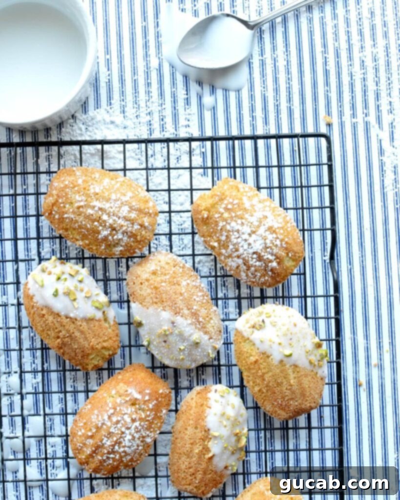Irresistible Gluten-Free Madeleines 2 Gluten-free madeleines on a cooling rack, showcasing their beautiful scalloped shape and golden color.