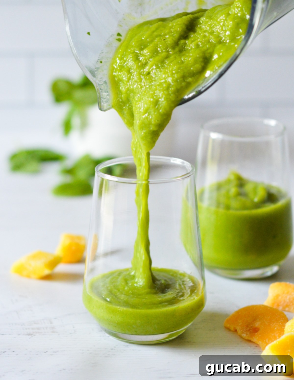Panera's Emerald Zest Smoothie 6 A freshly blended green smoothie being poured from the blender into a clear glass, showing its smooth, rich texture and inviting color.