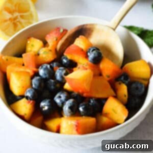 a bowl of peach blueberry salad.