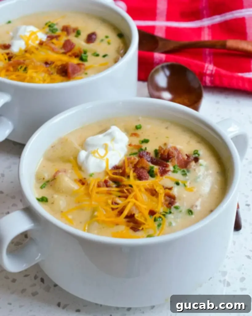 A tempting bowl of loaded potato soup, adorned with melted cheese and crispy bacon bits.