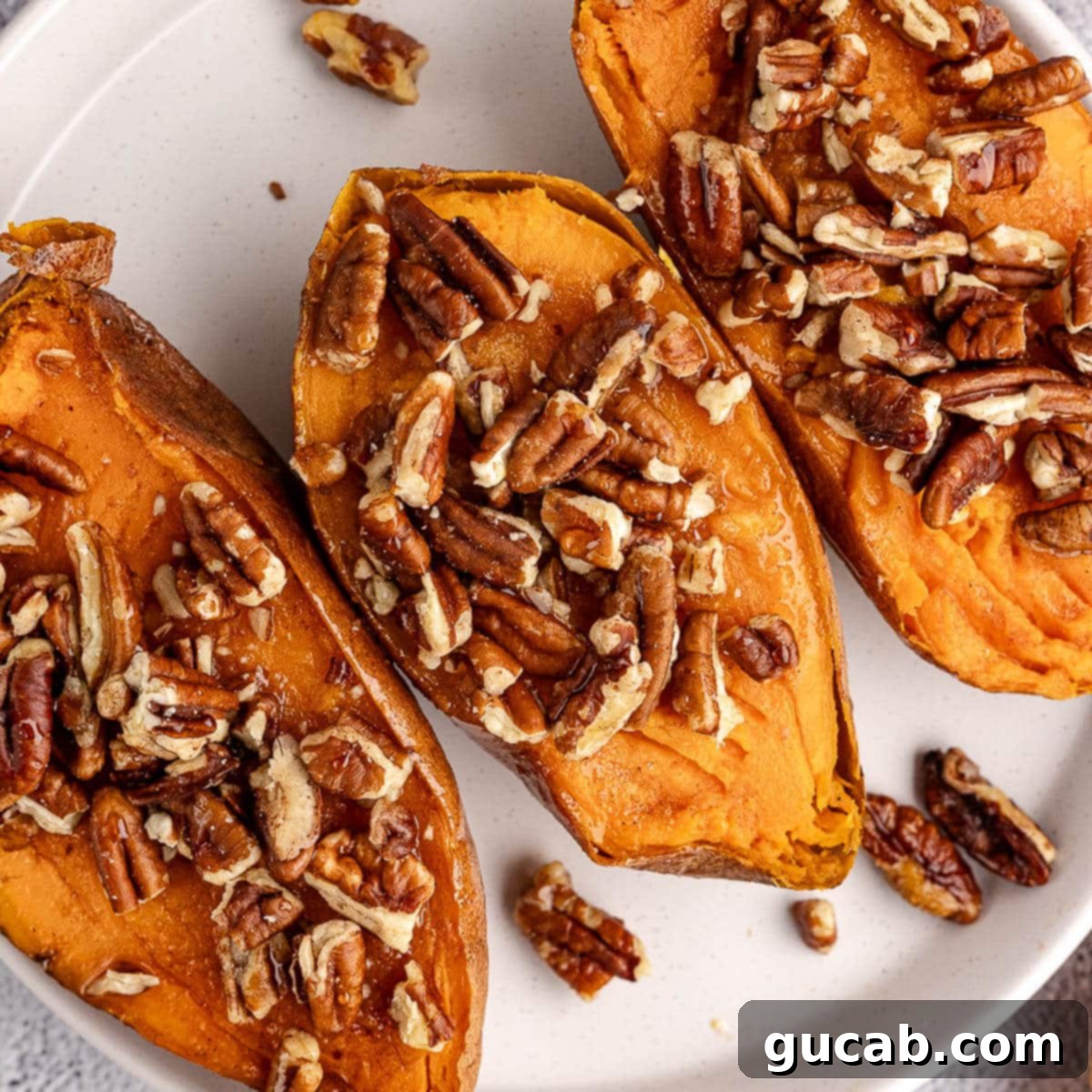 baked sweet potatoes with pecans on top.