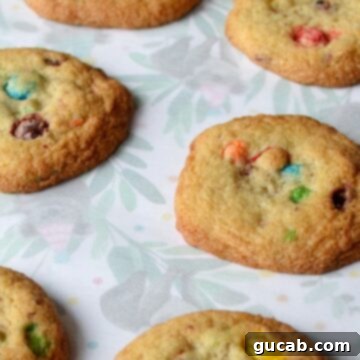 Gluten free m&m cookies laying flat on parchment paper