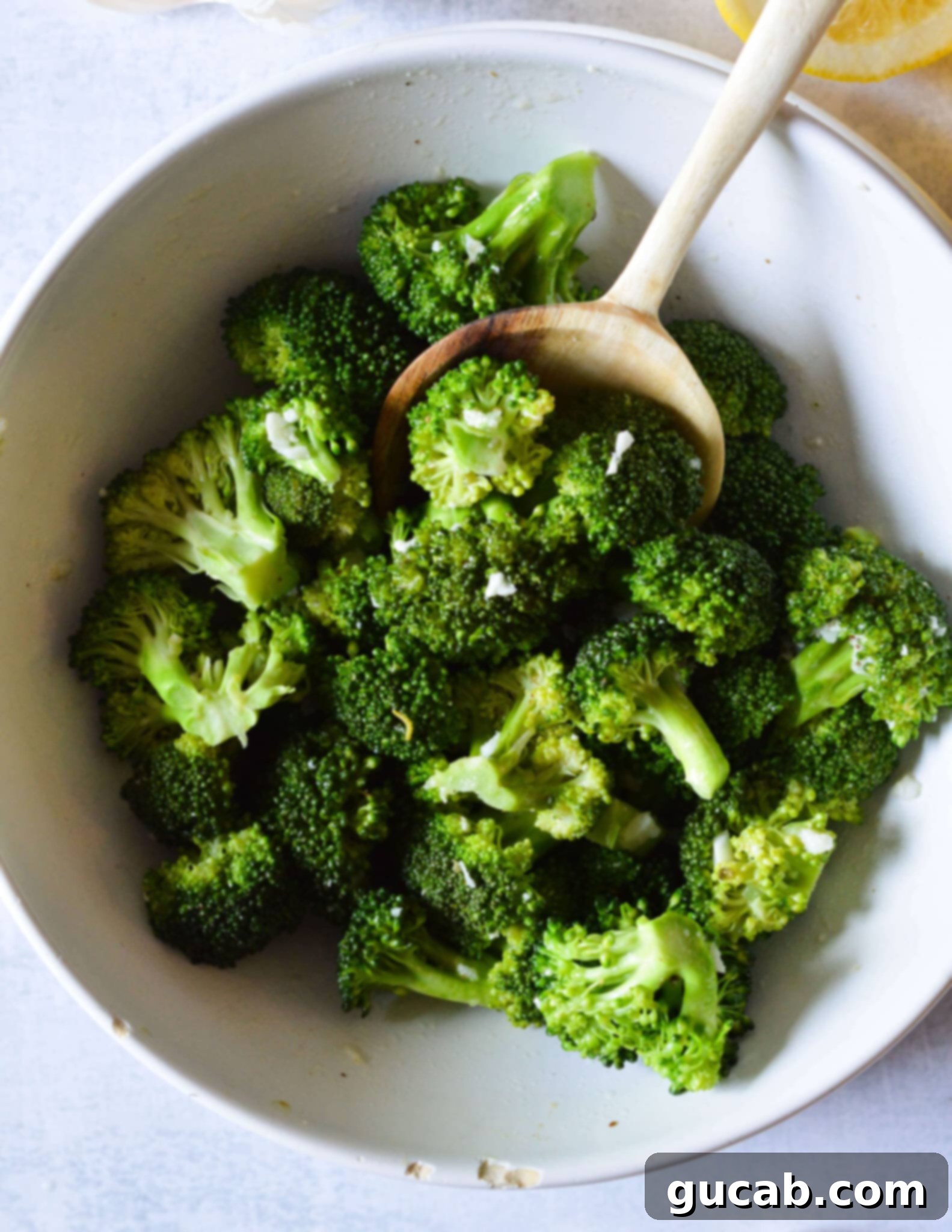 Easy 10-Minute Garlic Butter Broccoli 11 A bowl of vibrant green steamed broccoli perfectly coated in garlic butter, with a hint of Parmesan.