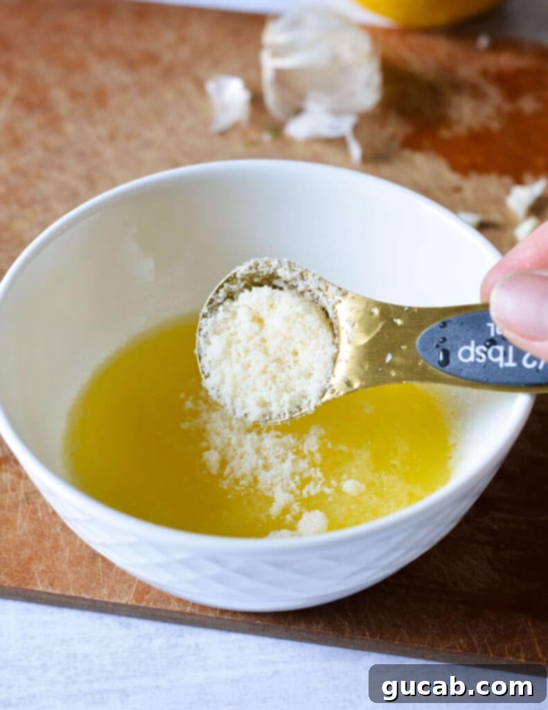 Easy 10-Minute Garlic Butter Broccoli 6 A bowl with melted butter and freshly grated Parmesan cheese, ready for mixing.