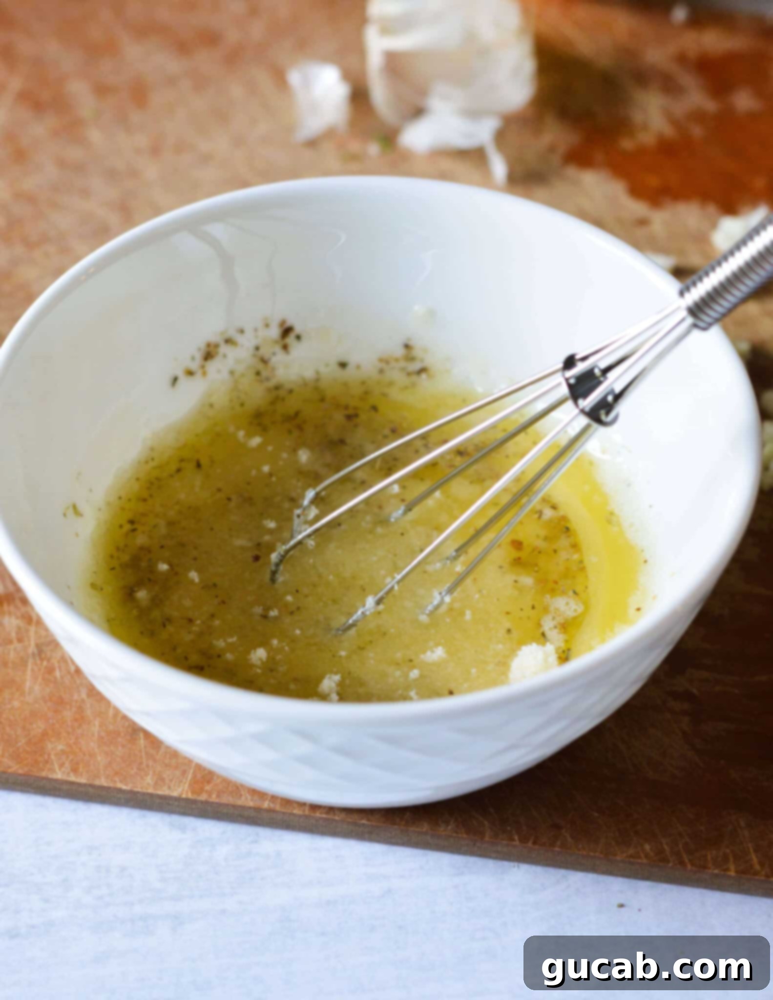 Easy 10-Minute Garlic Butter Broccoli 7 A close-up of melted butter, Parmesan, oregano, and salt mixed together in a bowl, forming the flavorful garlic butter sauce.