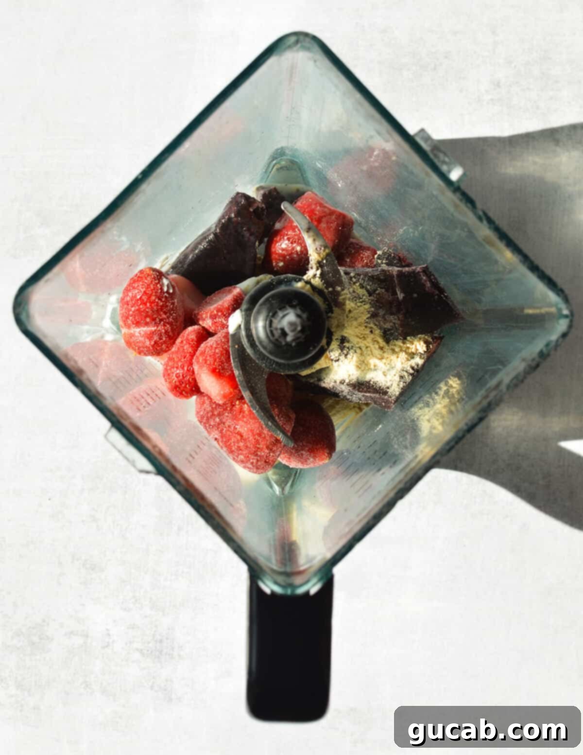 Protein Packed Acai Bowl 4 frozen strawberries, protein powder, acai, and peanut butter in a blender.