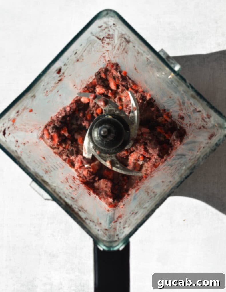 blended mixture of fruit and acai in a blender. 