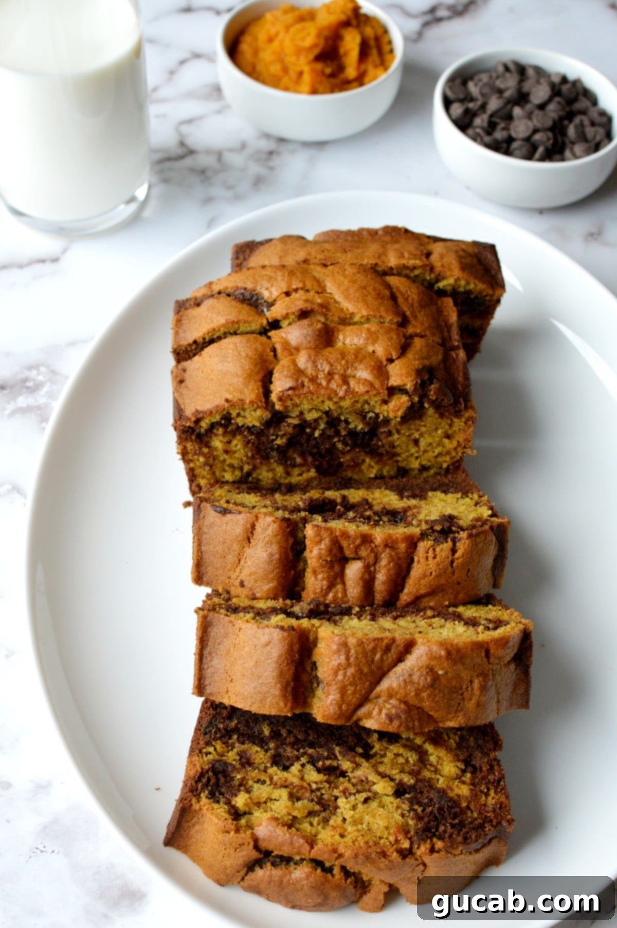 Heavenly Gluten Free Pumpkin Chocolate Bread 2 Slices of moist gluten-free pumpkin chocolate marble bread on a platter, showcasing the beautiful swirl.