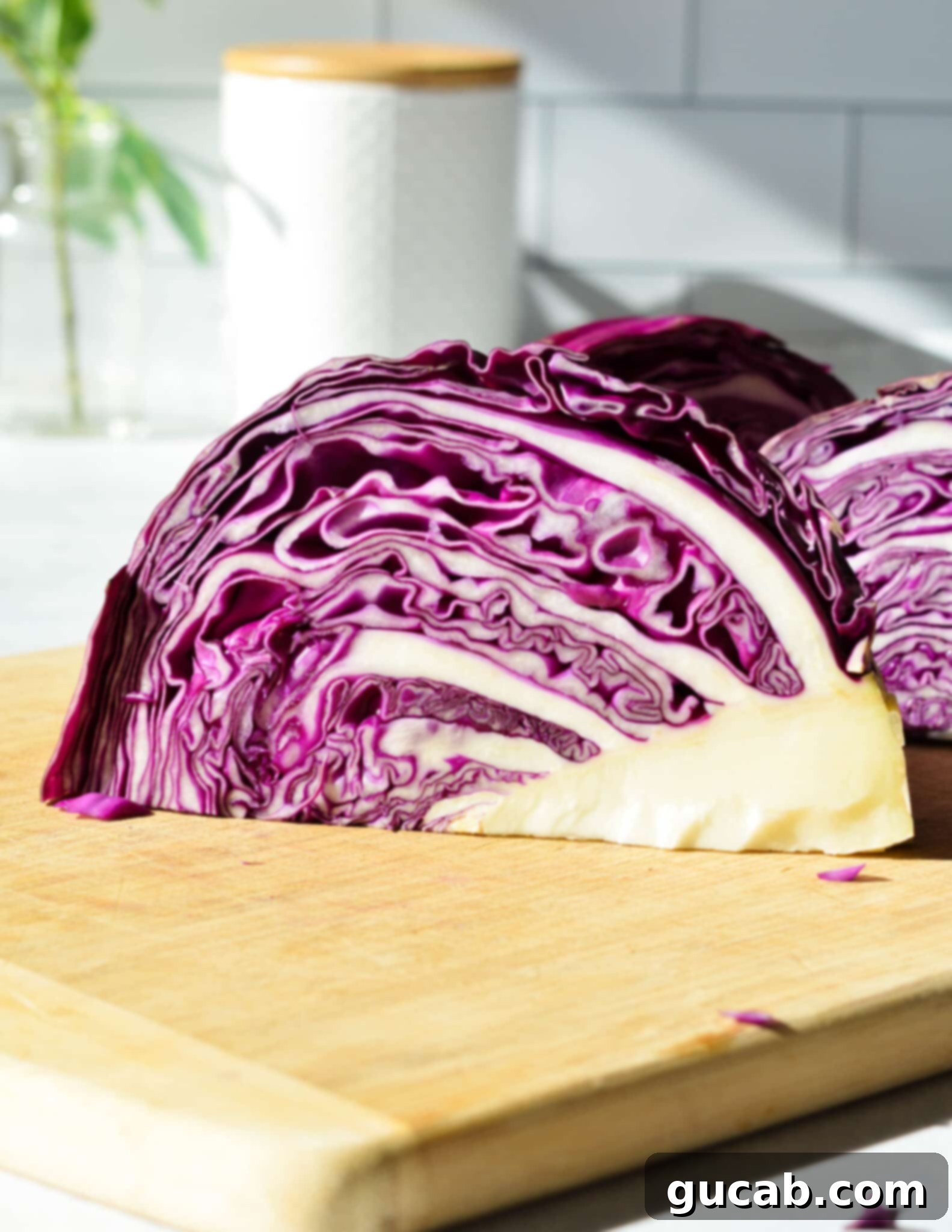 inside of cabbage shown on cutting board. 