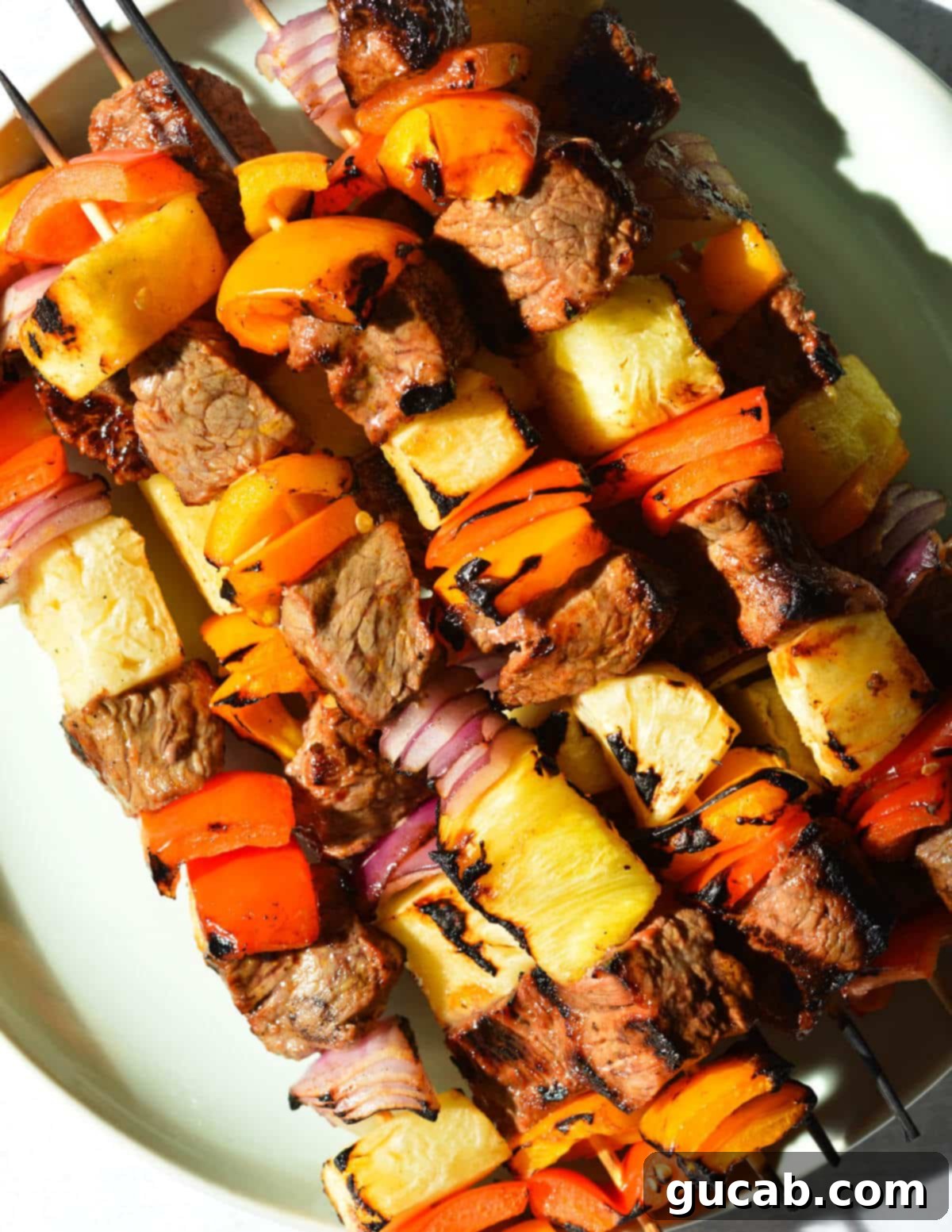 Perfectly grilled and caramelized steak kebabs arranged on a serving plate.