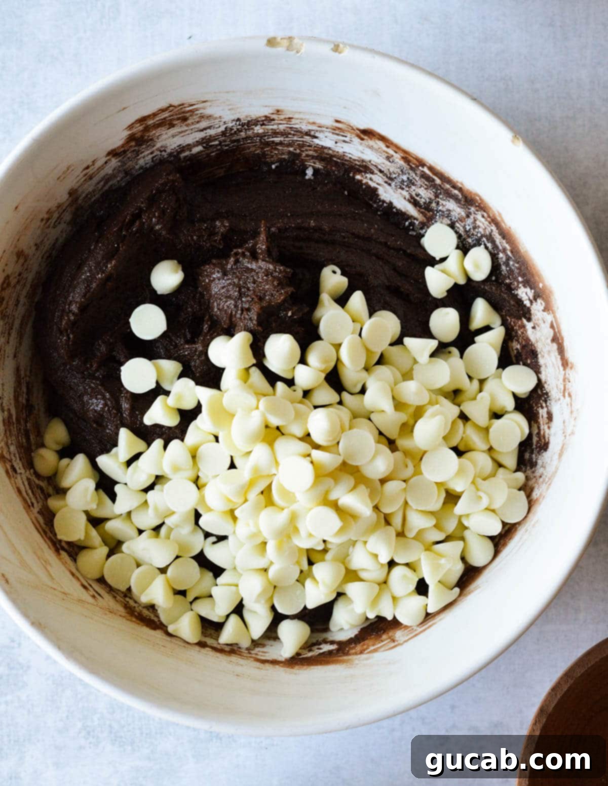 Chocolate cookie dough speckled with white chocolate chips, ready for scooping.