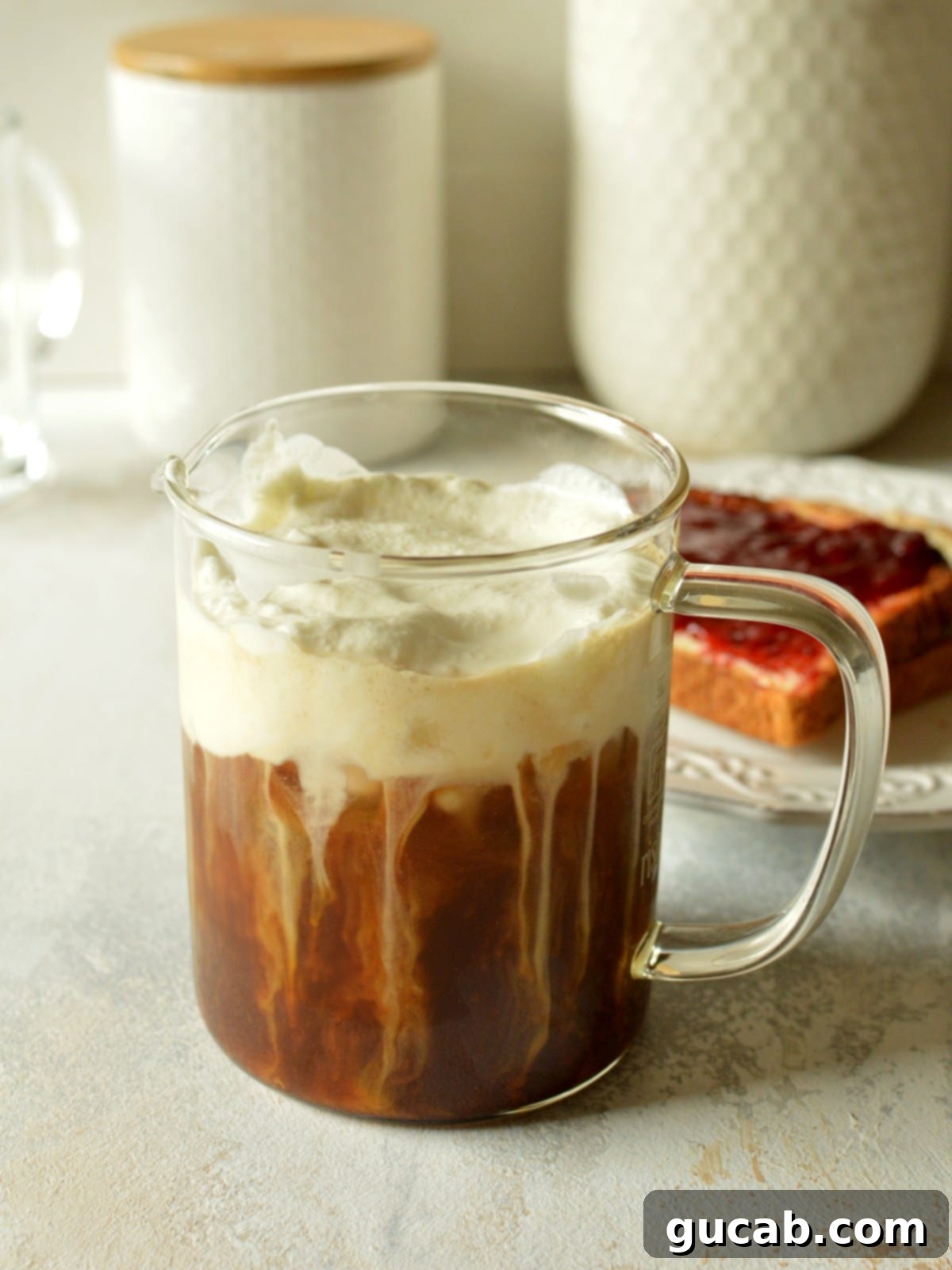 An inviting iced coffee topped with a generous layer of creamy sweet cream cold foam, ready to be enjoyed.