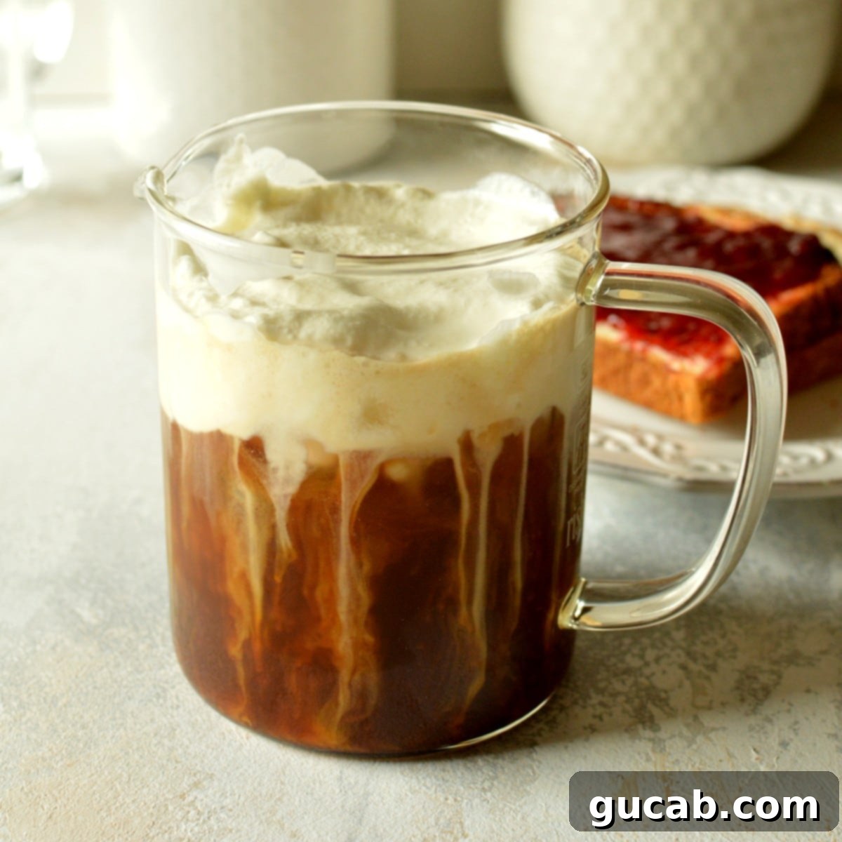 A refreshing cold brew coffee is elegantly topped with a thick layer of vanilla sweet cream cold foam, showcasing its perfect texture.