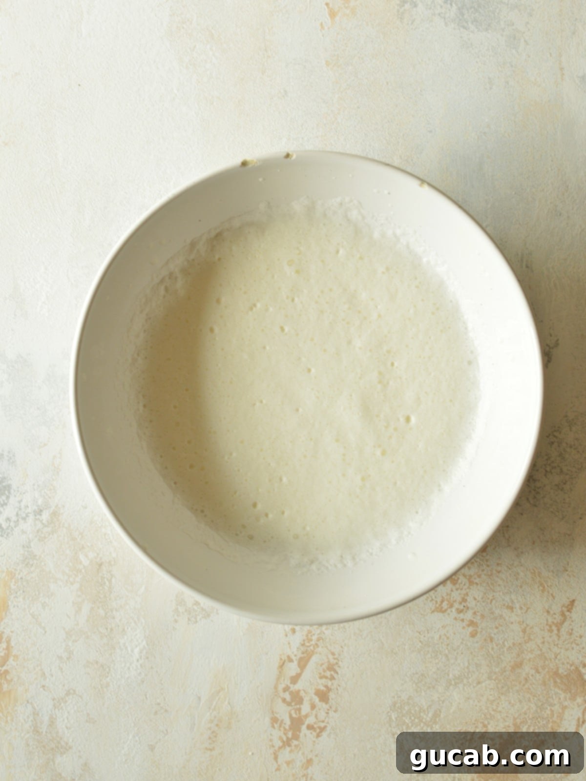 A bowl containing starbucks sweet cream cold foam, showing the results of a whisking method, slightly less thick than other methods.