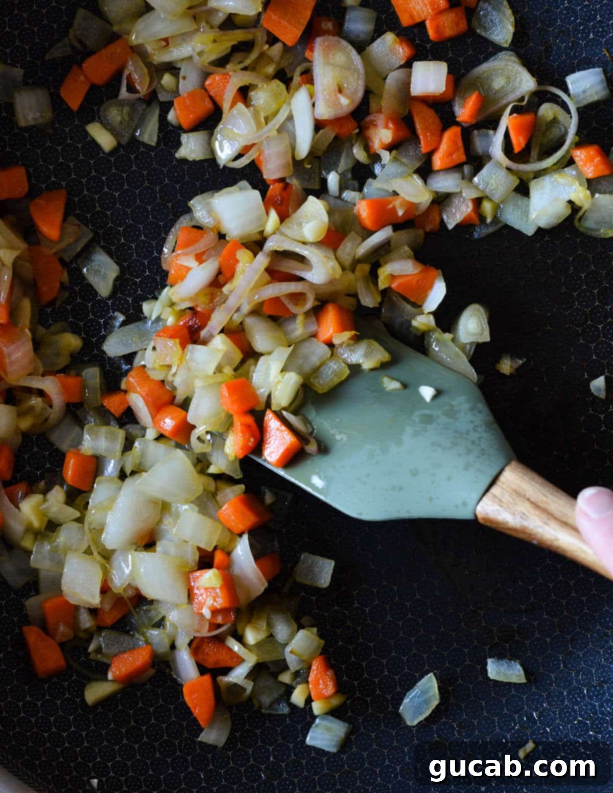 sauteed carrots, onion, garlic, and shallot in a skillet. 