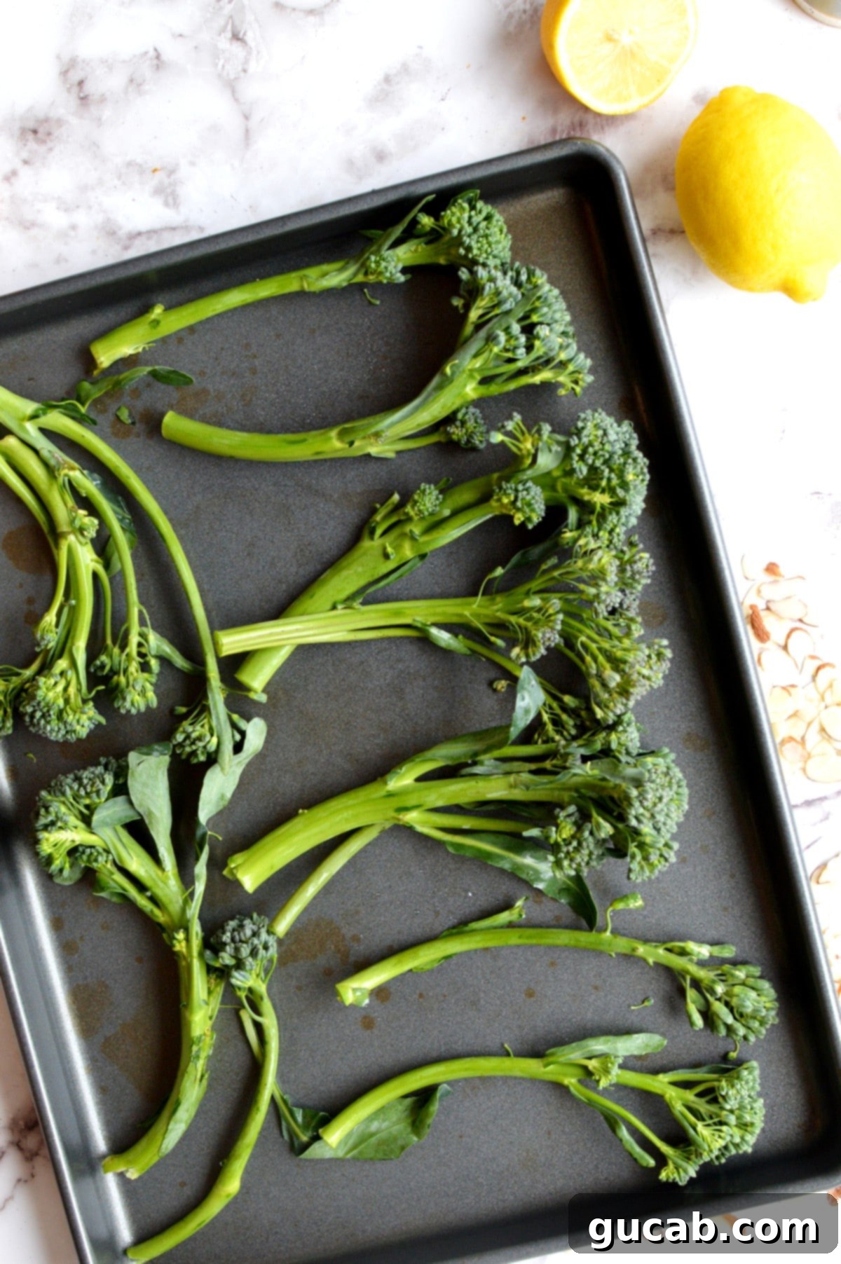 A sheet pan of tenderstem broccoli perfectly roasted to a crispy finish.