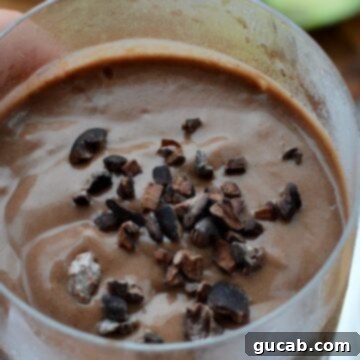 Peanut Butter Chocolate Avocado Smoothie topped with cocoa nibs