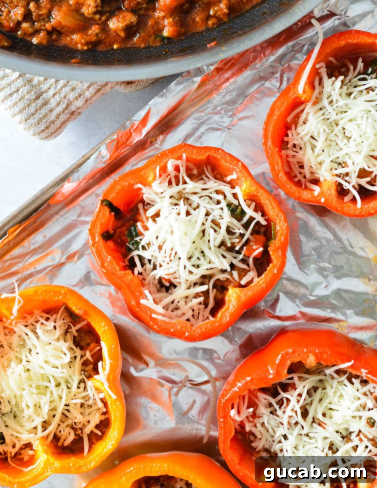 Bell peppers with meat sauce inside and a layer of mozzarella cheese on top.