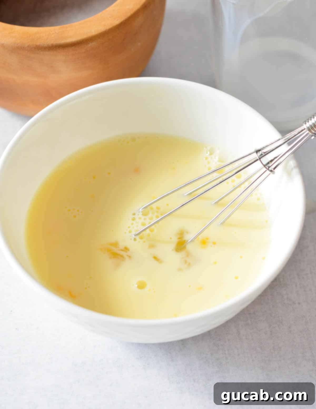 a bowl of whisked egg and milk. 