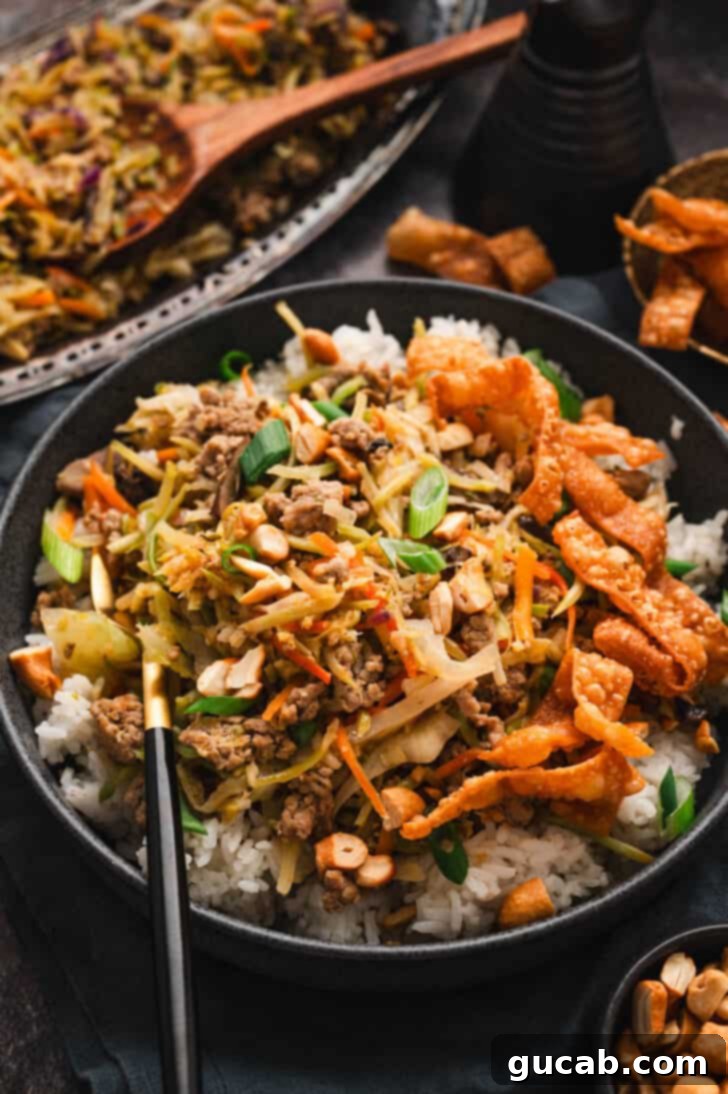 turkey egg roll in a bowl over white rice. 